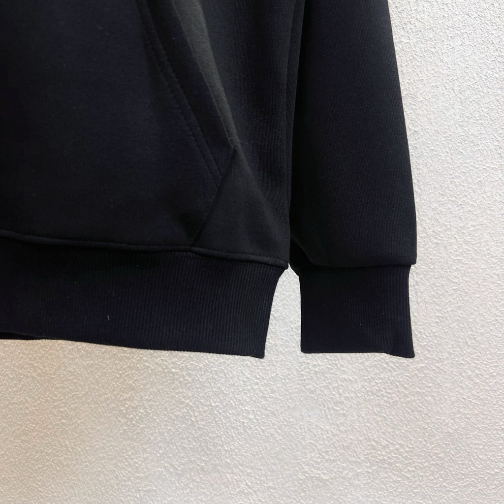 Dark zip-up hoodie sleeves with ribbed cuffs and hem