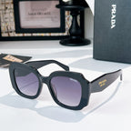 Black sunglasses with purple-tinted lenses and Prada Milano branding on the temple