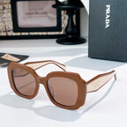 Brown sunglasses with taupe lenses and gold-tone Prada logo on the temple