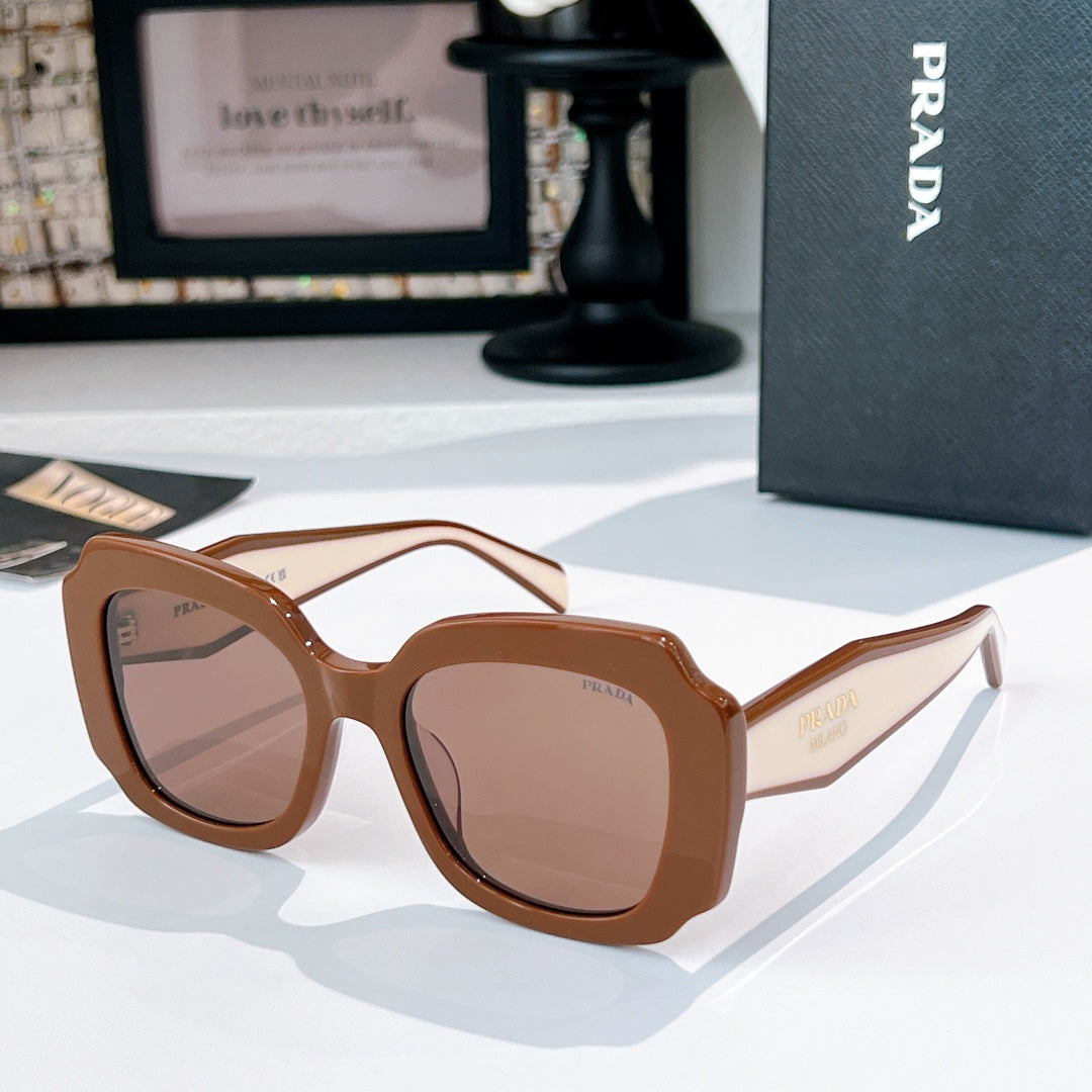 Brown sunglasses with taupe lenses and gold-tone Prada logo on the temple