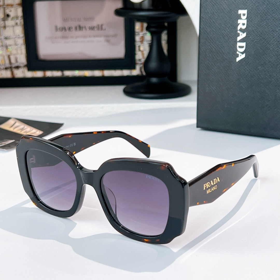 Black sunglasses with purple-tinted lenses and orange tortoise-style accents