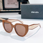 Prada sunglasses with brown frames and rose-tinted lenses.