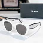 Prada sunglasses with white frames and dark tinted lenses.