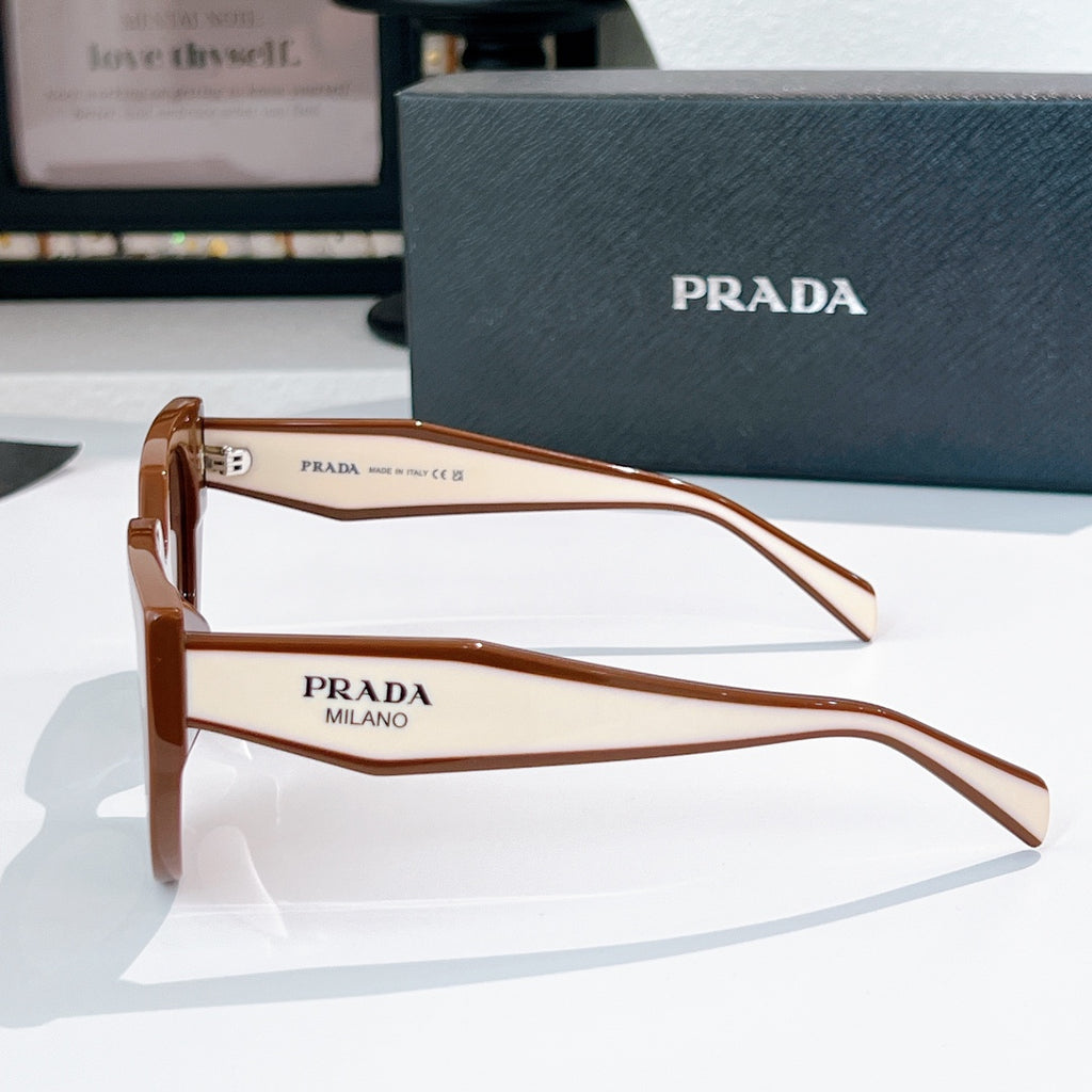 Prada sunglasses side view with brown frames and tinted lenses.