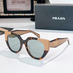 Prada sunglasses with tortoiseshell and tan frames, light tinted lenses.