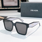 Black square sunglasses with dark tinted lenses and Prada logo on temple.