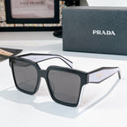 Black square sunglasses with gray tinted lenses and Prada logo on temple.