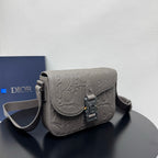 Dior embossed crossbody bag with flap and adjustable shoulder strap