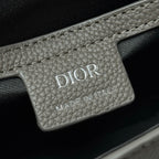 Dior logo leather patch on embossed bag with 'MADE IN ITALY' text