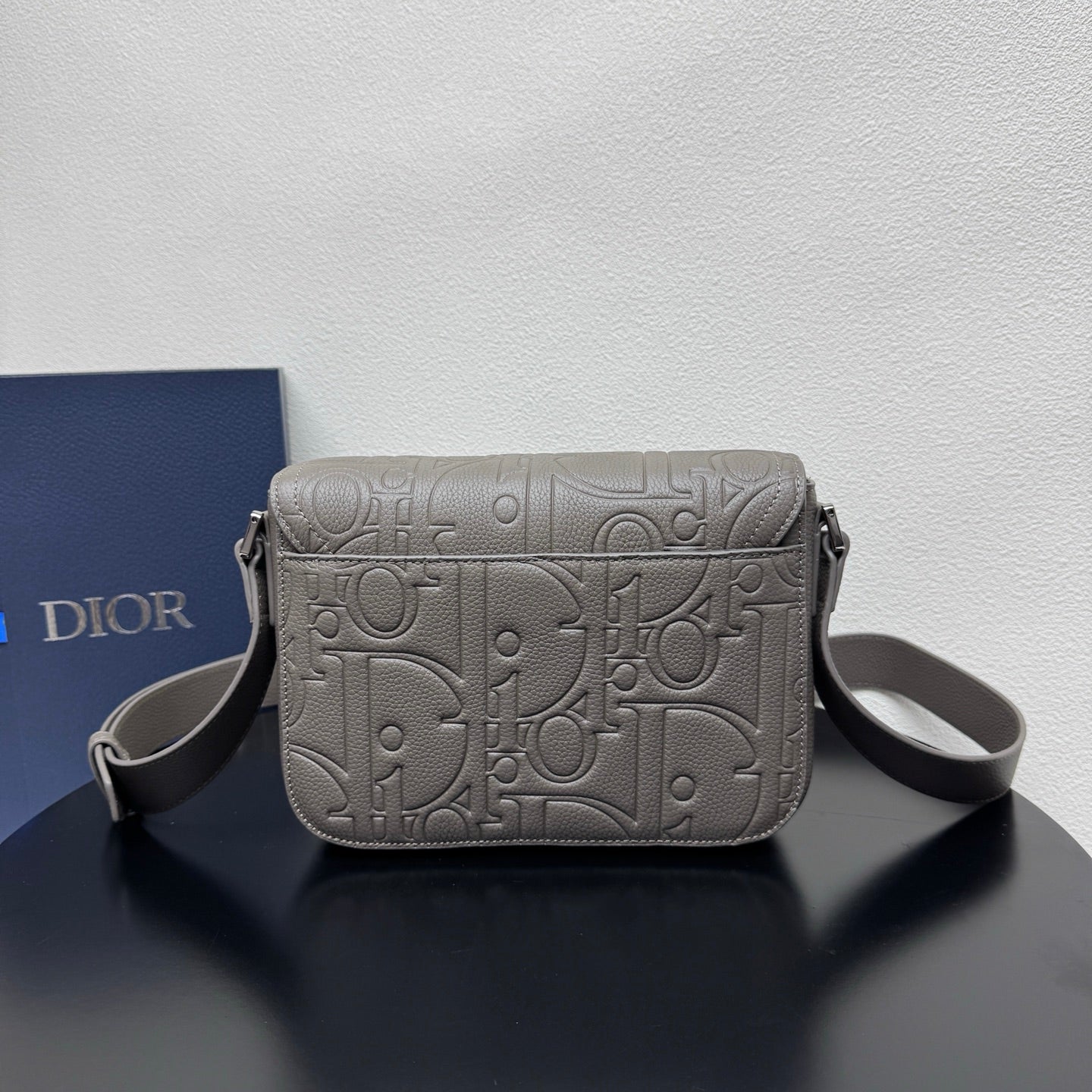 Dior embossed shoulder bag with structured flap and side straps