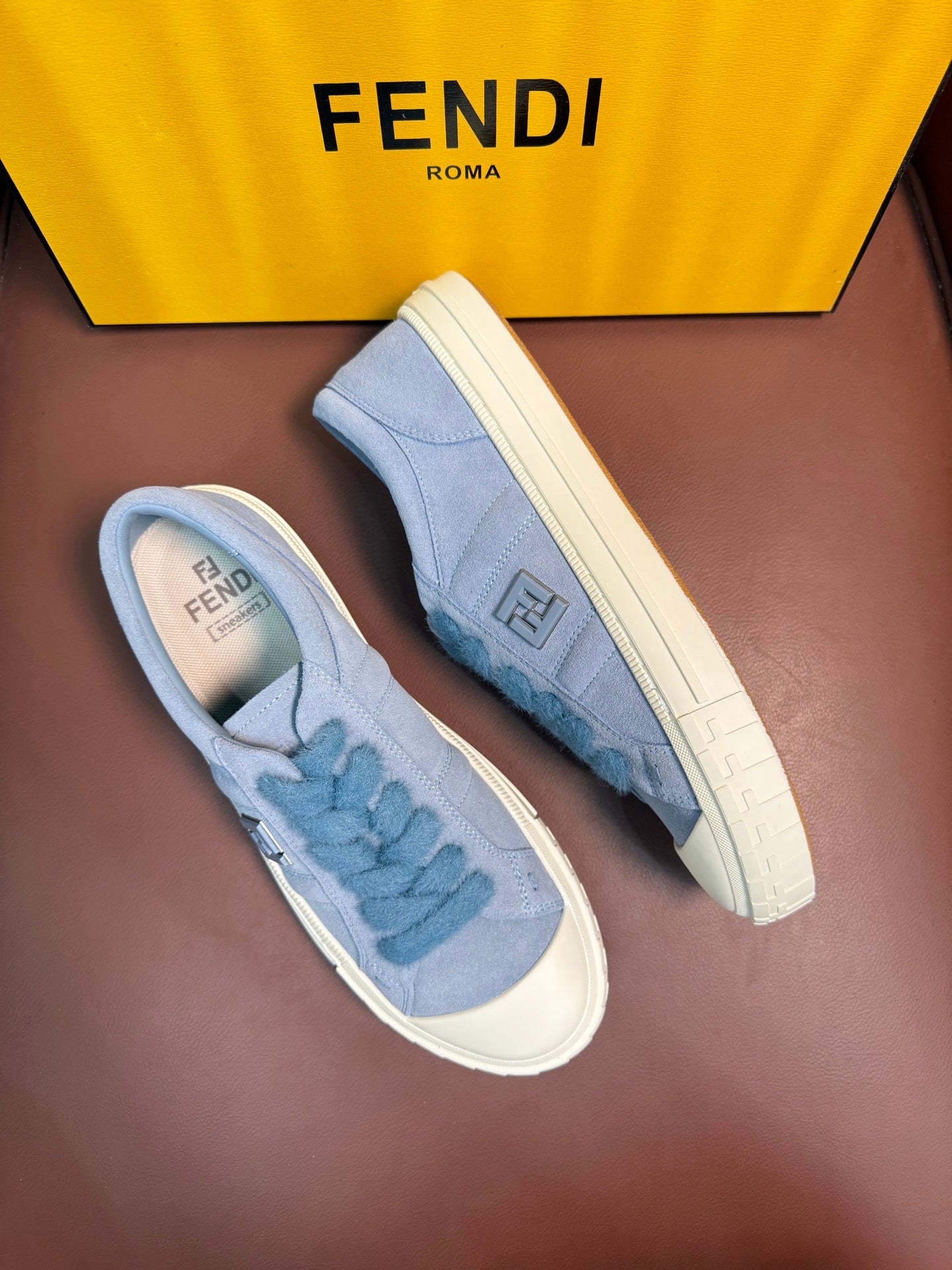 Fendi unisex light-blue slip-on sneakers, side view with Fendi logo on upper
