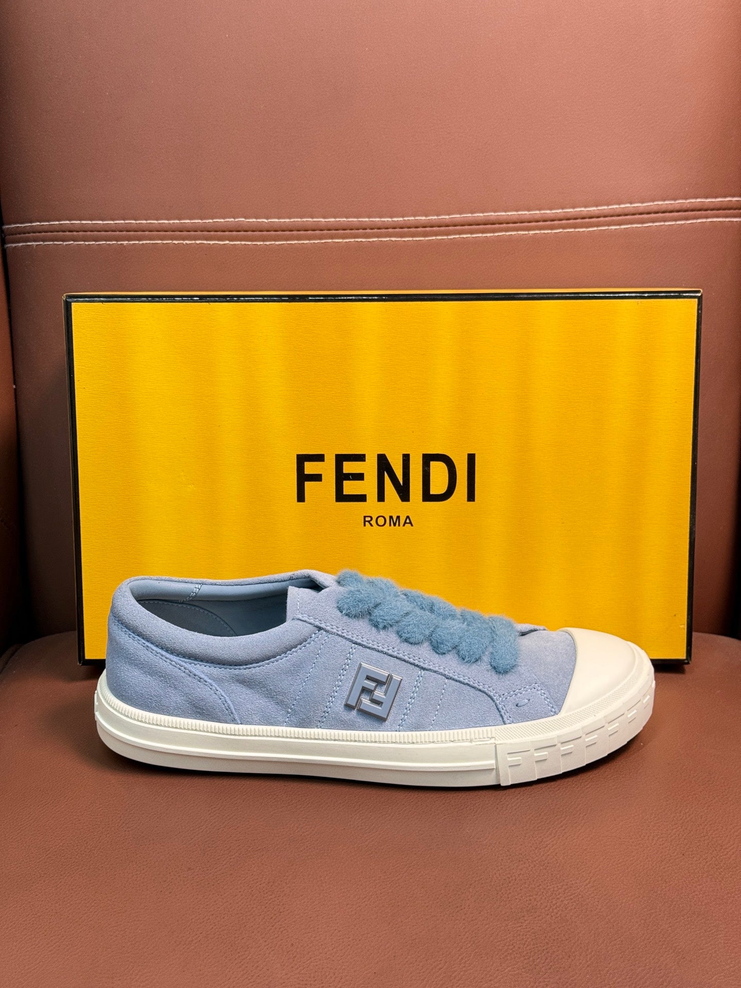 Fendi unisex light-blue slip-on sneakers with stitched Fendi logo patch and white sole