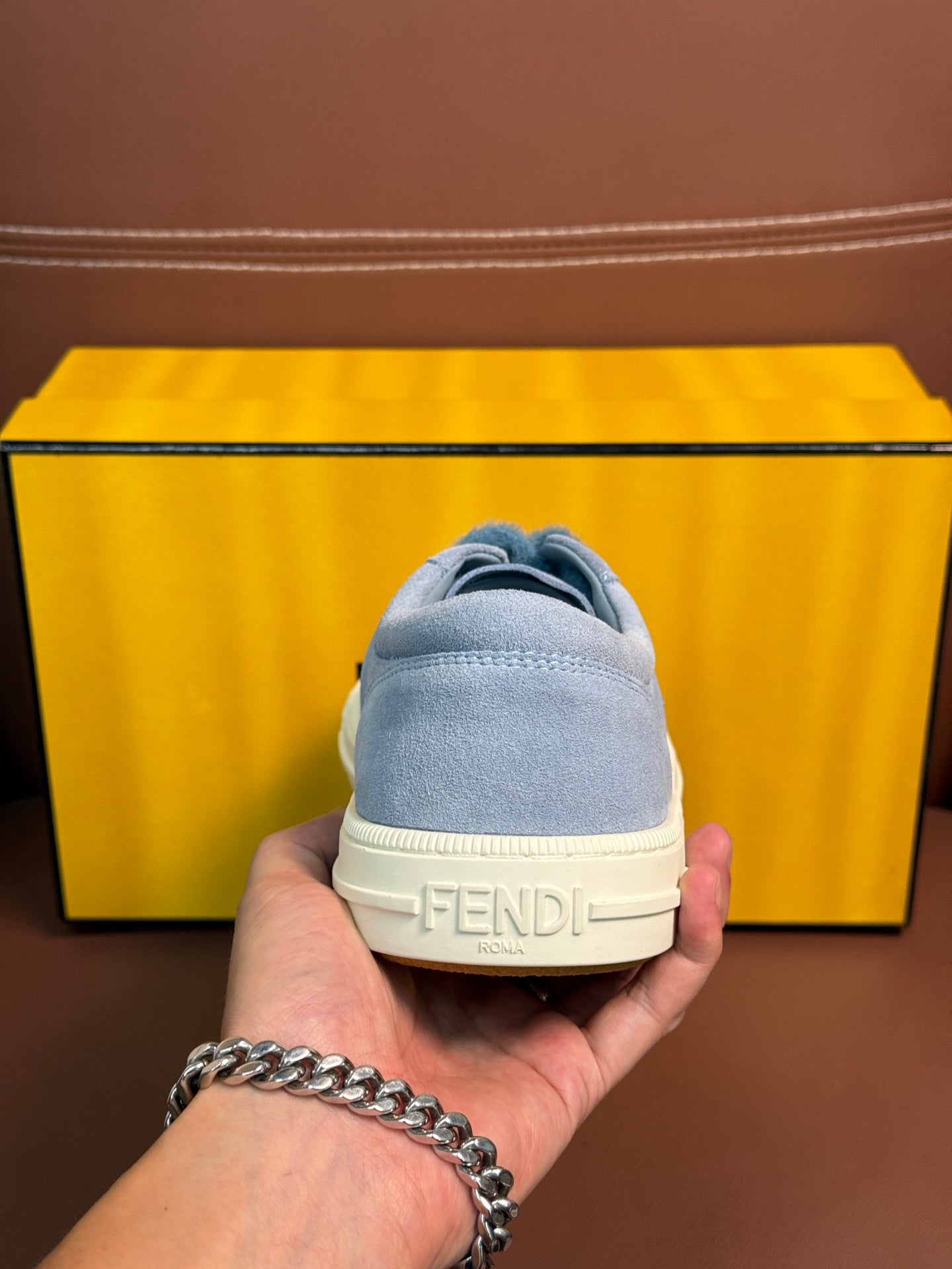 Fendi unisex light-blue sneakers heel close-up with FENDI logo on the back tab