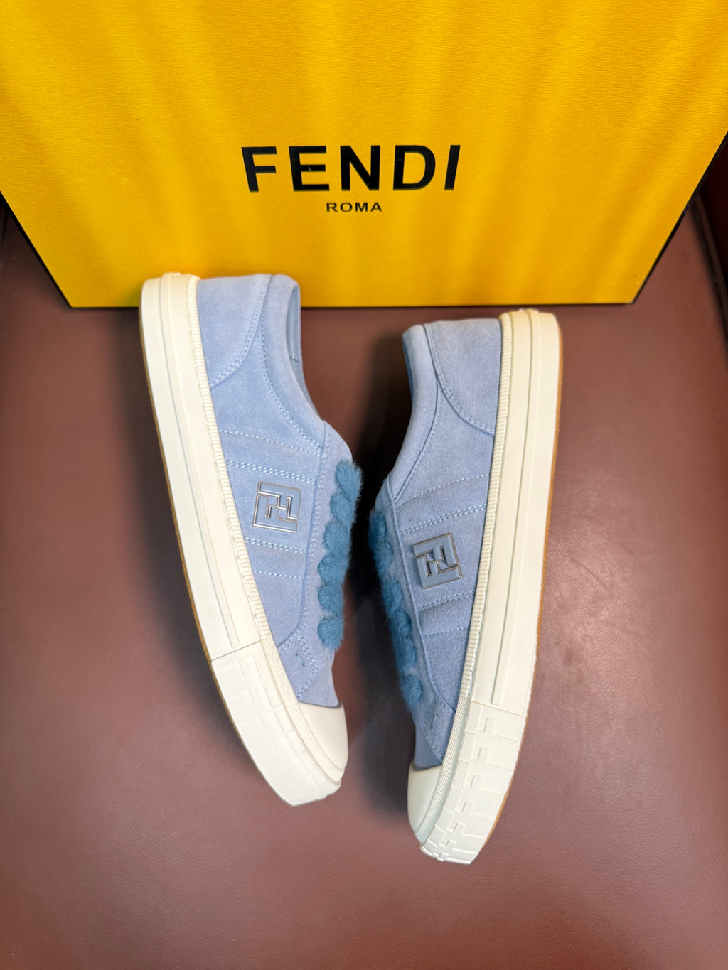 Fendi unisex light-blue slip-on sneakers, front angle with embossed Fendi logo