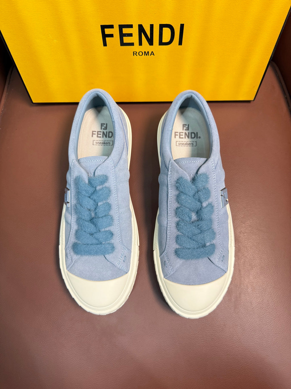 Fendi unisex light-blue slip-on sneakers with textured Fendi lace detail and white sole