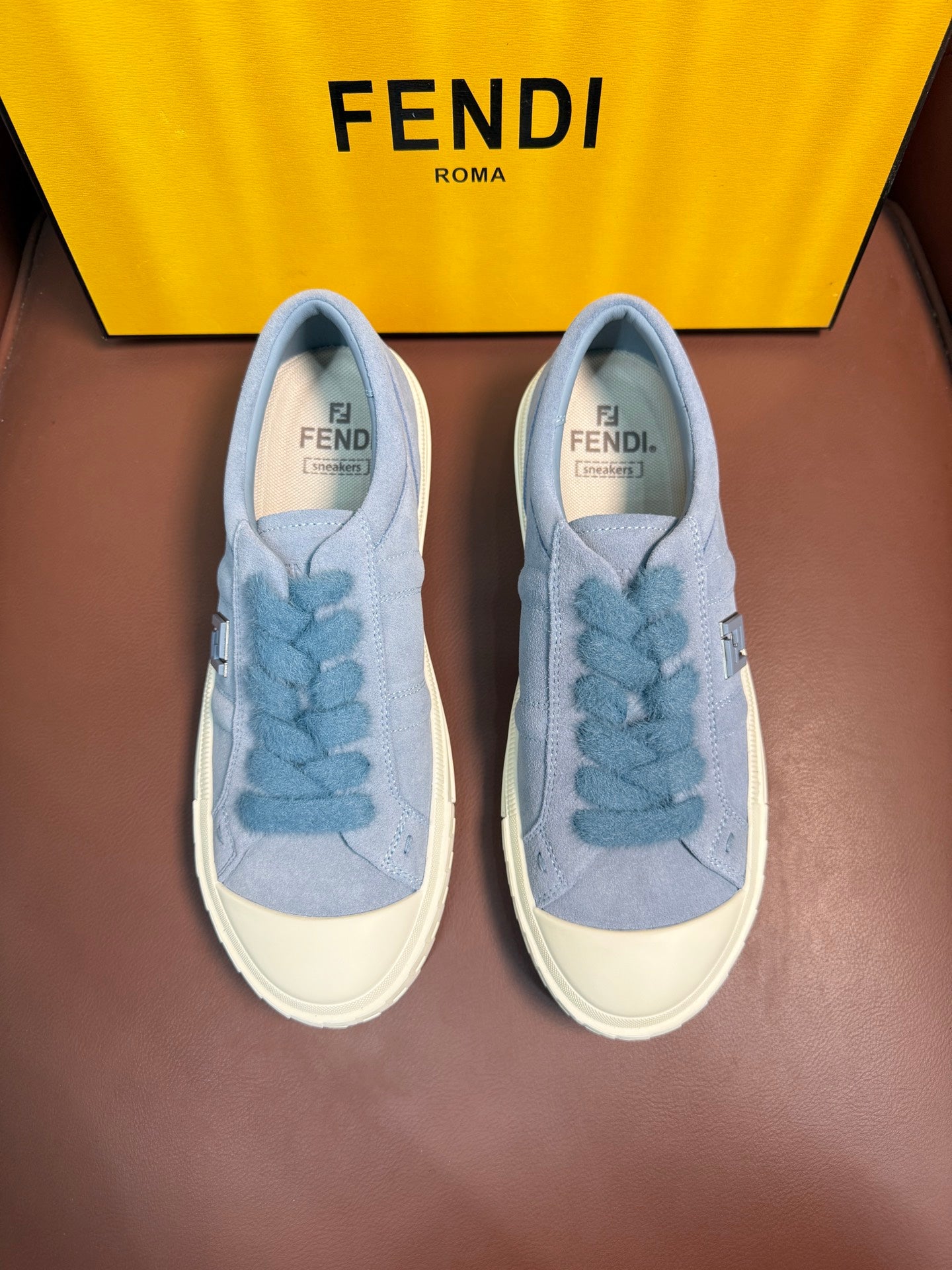 Fendi unisex light-blue slip-on sneakers with textured Fendi lace detail and white sole