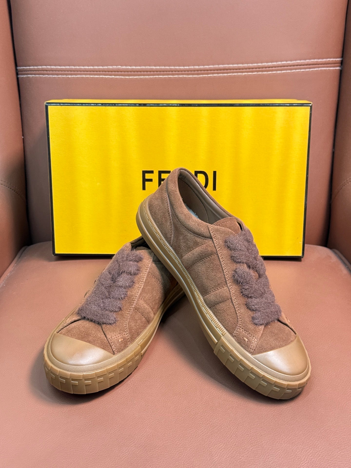 Fendi unisex suede sneakers pair, angled view showing lace-up and thick rubber sole