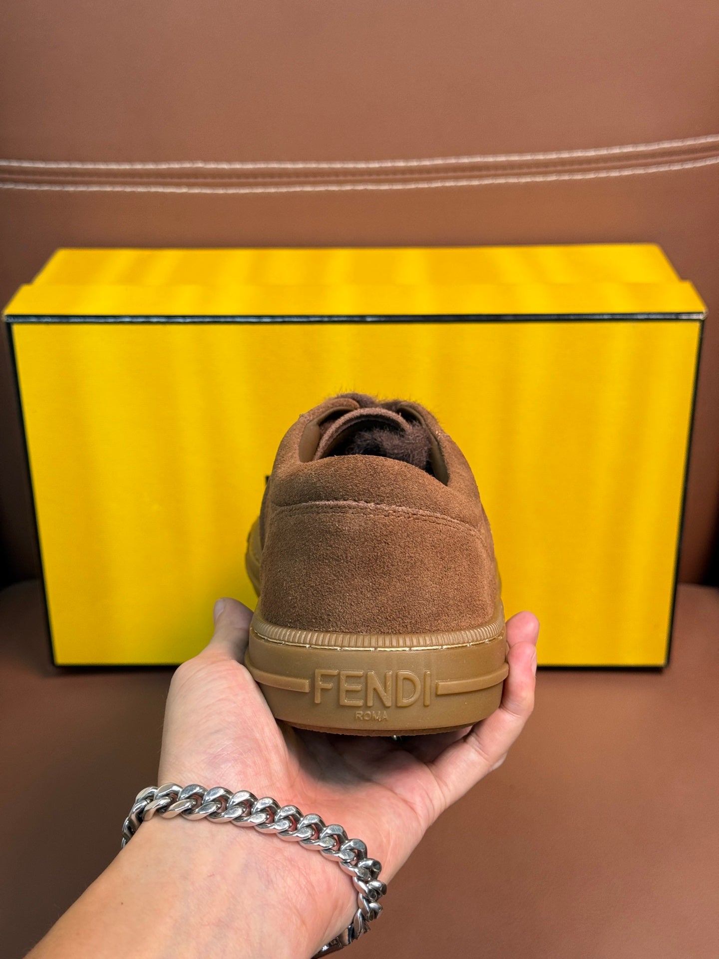 Fendi unisex suede sneakers, heel view with embossed Fendi logo on sole