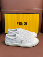 White Fendi unisex sneakers, front view with embossed logo and textured white sole