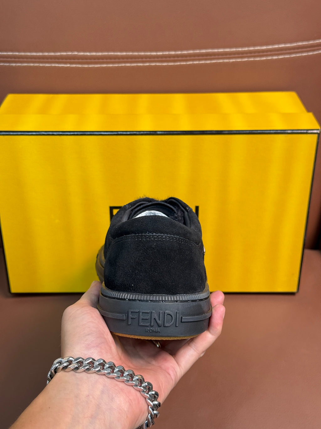 Fendi unisex sneaker heel view with dark suede upper and Fendi logo branding