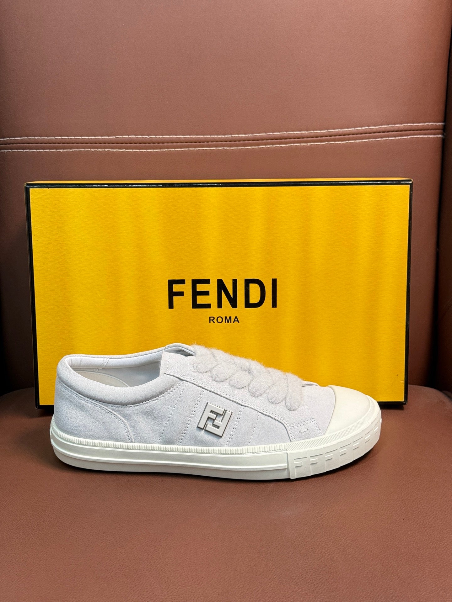 White Fendi unisex sneakers, side view with lace-up panel and square logo emblem