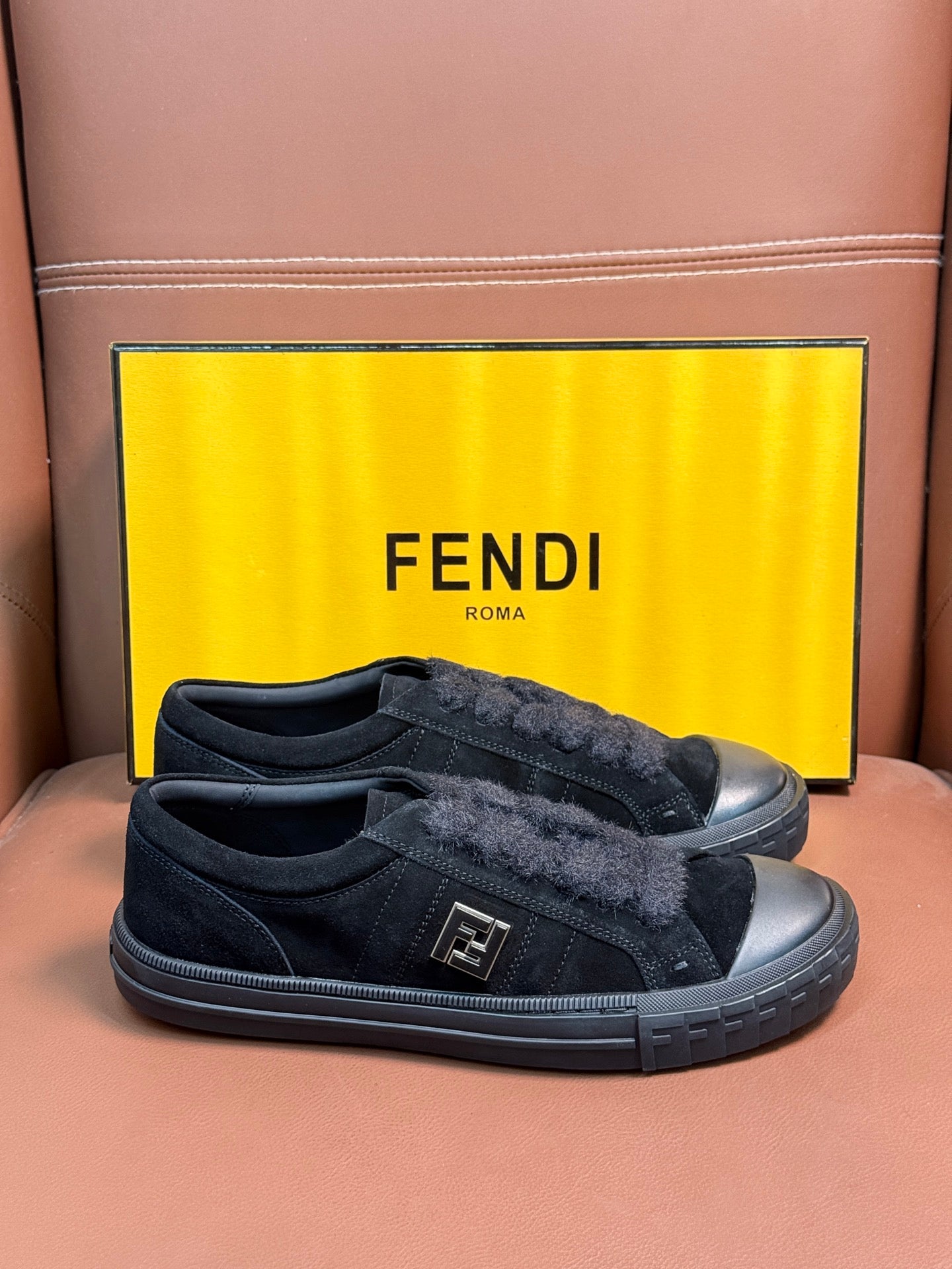 Fendi unisex slip-on sneakers in dark suede with front logo detail and chunky sole