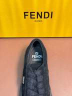 Fendi unisex sneaker interior view with dark suede upper and logo label