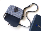 Dior crossbody bag with navy flap, blue monogram body, adjustable strap