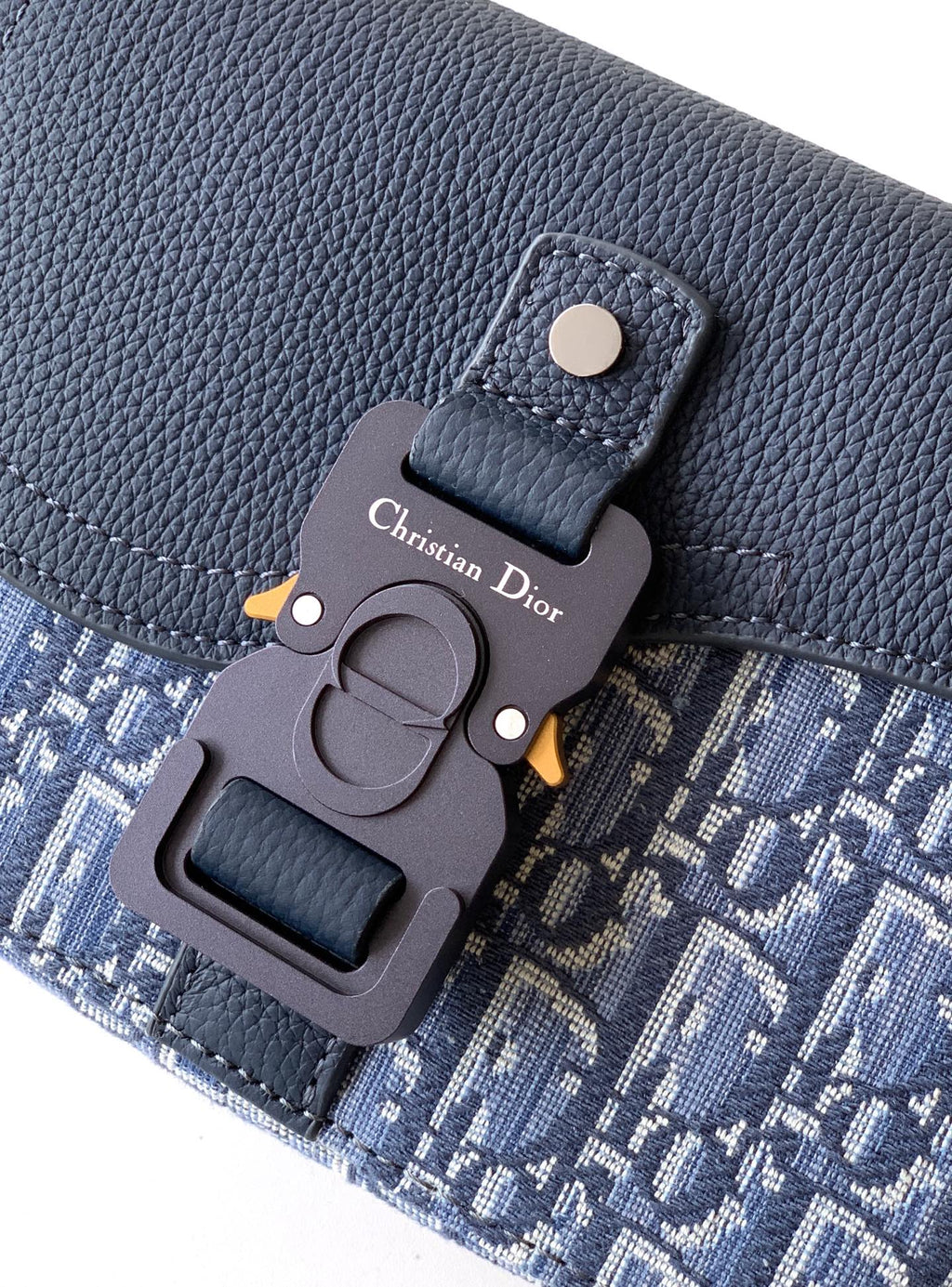 Dior bag charm on textured navy leather with blue monogram panel