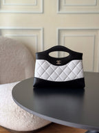 Chanel quilted mini handbag, black and white with top handle and CC logo