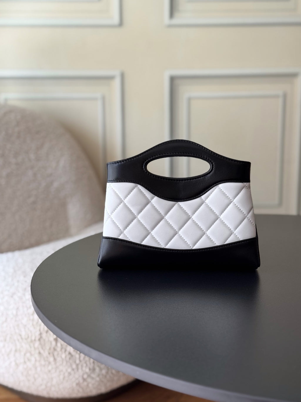 Chanel quilted mini handbag in black and white, front view with top handle