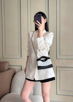 Chanel mini handbag worn crossbody, black and white quilted design