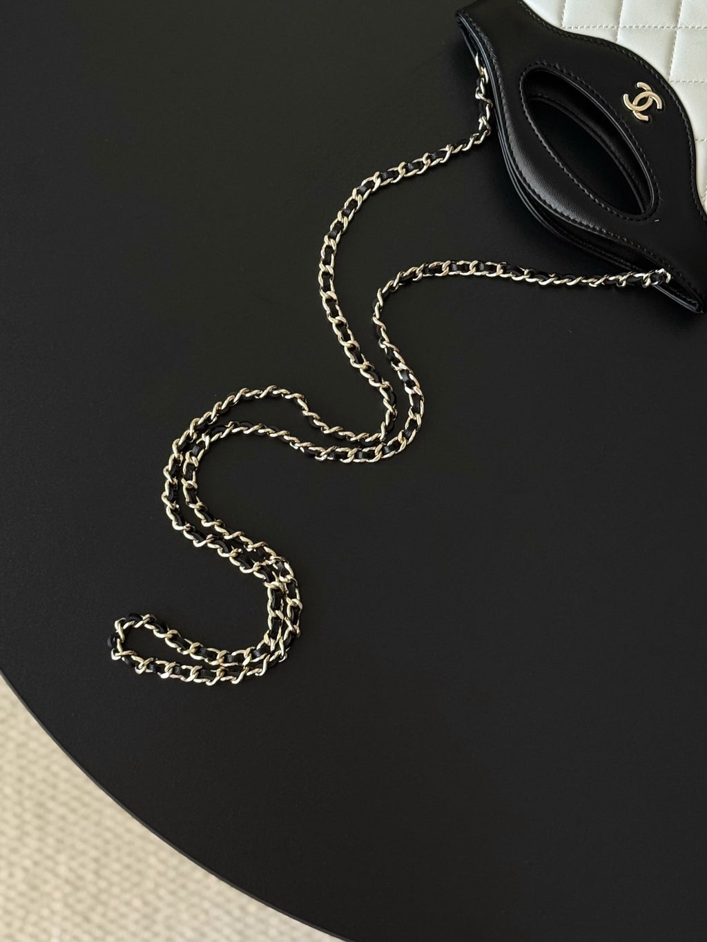Chanel mini handbag with chain strap, black and white top flap visible