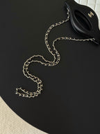 Chanel mini handbag with chain strap, black and white top flap visible