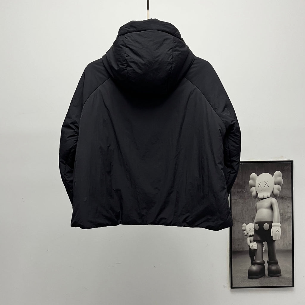 Back of black hooded puffer jacket with curved shoulders