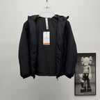 Black hooded puffer jacket with hanging neck label tag