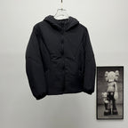 Black hooded puffer jacket, front view on hanger