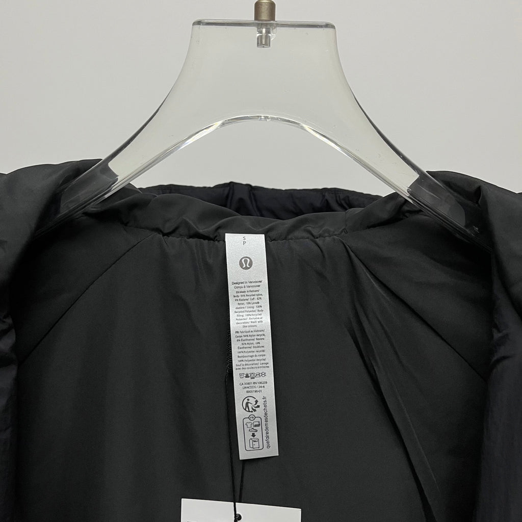 Black puffer jacket interior with care label at neck
