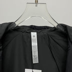 Black puffer jacket interior with care label at neck