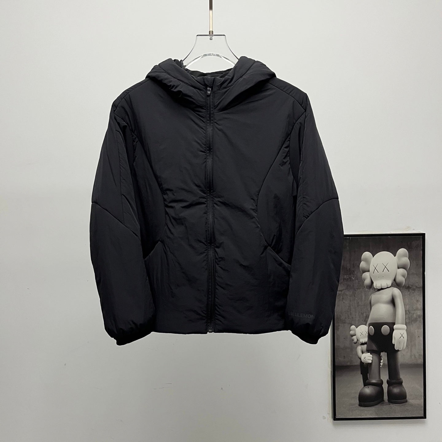 Black puffer jacket with hood and front zipper
