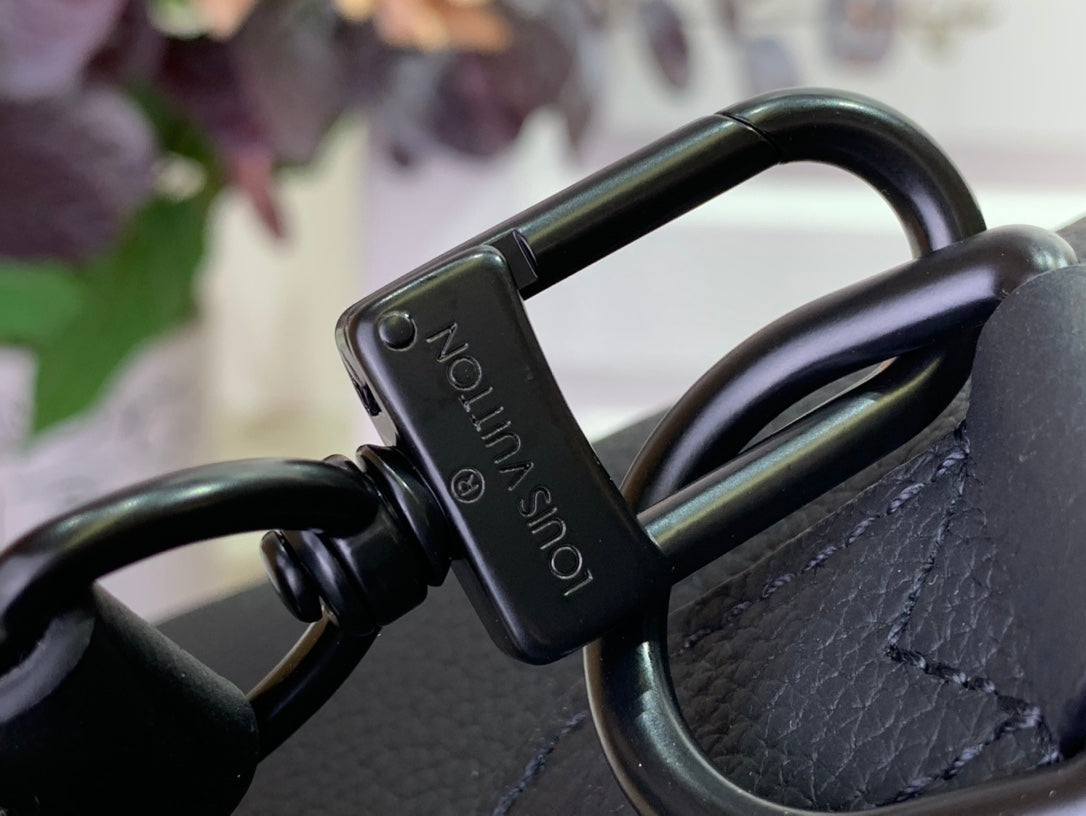 Leather bag strap hardware with Louis Vuitton logo, close-up