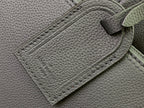 Embossed Louis Vuitton logo on textured leather panel, close-up