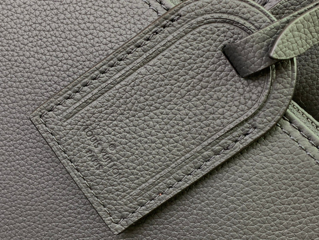 Embossed Louis Vuitton logo on textured leather panel, close-up
