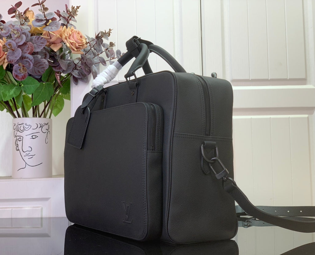 Leather briefcase bag in dark charcoal, side view with shoulder strap and clasp