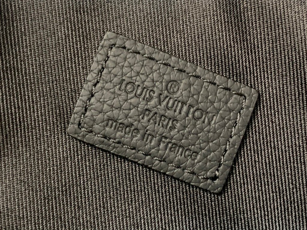 Louis Vuitton fabric label on bag lining, stitched label close-up