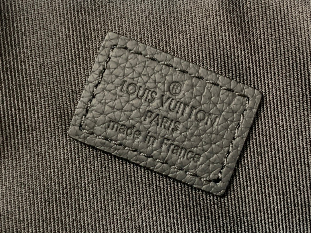 Louis Vuitton fabric label on bag lining, stitched label close-up
