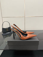 Ladies' YSL two-tone orange-and-black pointed-toe pumps with stiletto heels, side view