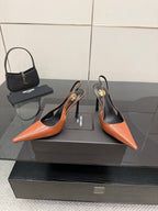 Ladies' YSL two-tone orange-and-black pointed-toe pumps with stiletto heels, pair shown