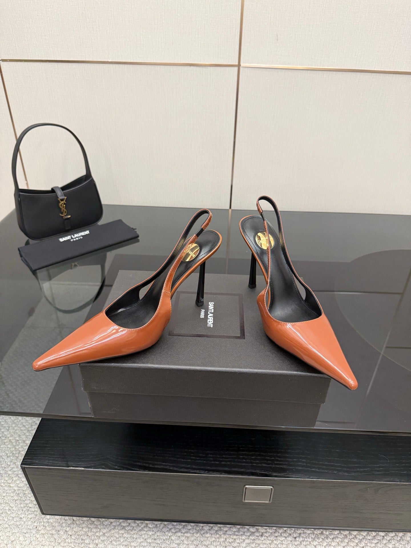 Ladies' YSL two-tone orange-and-black pointed-toe pumps with stiletto heels, pair shown
