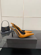 Women's orange-and-black slingback pumps with high stiletto heel and gold detail.